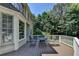 Relaxing outdoor deck with table and chairs, ideal for enjoying the serene, wooded surroundings at 4260 River Club Dr, Cumming, GA 30041