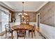 Formal dining room with wallpaper, and wood table with seating for four at 4260 River Club Dr, Cumming, GA 30041