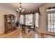 Sunny dining area featuring a wooden hutch, chandelier, and natural light streaming through large windows at 4260 River Club Dr, Cumming, GA 30041