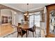 Open dining room with hardwood floors, archway to living room, and a traditional wooden dining set at 4260 River Club Dr, Cumming, GA 30041
