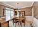 Inviting dining room with decorative lighting, wainscoting, and a beautiful wood dining set at 4260 River Club Dr, Cumming, GA 30041