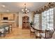 Open-concept design with dining area featuring hutch, chandelier, and hardwood floors, connecting to kitchen at 4260 River Club Dr, Cumming, GA 30041