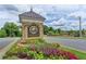 Elegant stone entrance sign with colorful flower beds and well-maintained landscaping at 4260 River Club Dr, Cumming, GA 30041