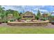 Stone sign to the community, surrounded by manicured landscaping and lush greenery at 4260 River Club Dr, Cumming, GA 30041