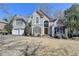 Charming two-story home with a well-manicured lawn and inviting curb appeal on a sunny day at 4260 River Club Dr, Cumming, GA 30041