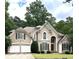 Charming two-story home with a well-manicured lawn and attached two-car garage at 4260 River Club Dr, Cumming, GA 30041