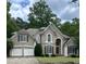 Charming traditional home featuring a two-car garage, shutters and meticulously maintained landscaping at 4260 River Club Dr, Cumming, GA 30041