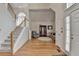 Bright foyer with hardwood floors, staircase, and neutral decor at 4260 River Club Dr, Cumming, GA 30041