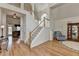 Spacious foyer with hardwood floors, staircase, and view into the living spaces, creating an inviting atmosphere at 4260 River Club Dr, Cumming, GA 30041