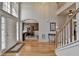 Well-lit foyer with hardwood floors, staircase, and a glimpse into the formal dining room at 4260 River Club Dr, Cumming, GA 30041