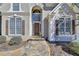 Close-up of the inviting front entrance with stone walkway, tall windows, and a stylish front door at 4260 River Club Dr, Cumming, GA 30041