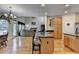 Open kitchen with a granite island, breakfast bar and hardwood floors connected to living room at 4260 River Club Dr, Cumming, GA 30041