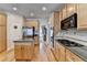 Contemporary kitchen with stainless steel appliances, an island, and light wood cabinetry throughout at 4260 River Club Dr, Cumming, GA 30041