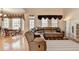 Bright living room with stone fireplace, large windows and a large comfortable leather sofa at 4260 River Club Dr, Cumming, GA 30041