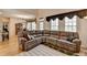 Bright living room with large windows, hardwood floors and a large comfortable leather sofa at 4260 River Club Dr, Cumming, GA 30041
