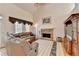 Bright living room with stone fireplace, hardwood floors, vaulted ceiling and leather sofa at 4260 River Club Dr, Cumming, GA 30041