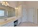 Bathroom with double sinks, vanity, tiled floors, walk-in shower, bathtub, and natural light at 4260 River Club Dr, Cumming, GA 30041