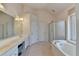 Bathroom with double sinks, tiled floors, a bathtub, a shower, and natural light at 4260 River Club Dr, Cumming, GA 30041