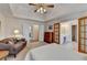 Comfortable bedroom featuring a tray ceiling, ceiling fan, and ensuite bathroom entry at 4260 River Club Dr, Cumming, GA 30041