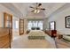 Spacious main bedroom with tray ceilings, fan, natural light and access to ensuite bathroom at 4260 River Club Dr, Cumming, GA 30041