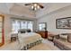 Bright bedroom features a ceiling fan, natural light, and space for a queen bed at 4260 River Club Dr, Cumming, GA 30041