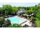 A large rectangular pool with lounge chairs and a clubhouse with covered decks surrounded by trees at 4260 River Club Dr, Cumming, GA 30041