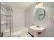 Clean bathroom features a bathtub, toilet and vanity with round mirror at 1975 Hunt Crossing Ct, Lawrenceville, GA 30043