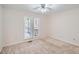 This is a bright bedroom with a window leading to a balcony and neutral-toned walls at 1975 Hunt Crossing Ct, Lawrenceville, GA 30043