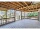 Large deck with wood ceiling and railings overlooks the backyard and trees at 1975 Hunt Crossing Ct, Lawrenceville, GA 30043