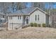 Charming exterior view of home featuring an attached garage and landscaped yard at 1975 Hunt Crossing Ct, Lawrenceville, GA 30043