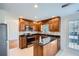 This is a cozy kitchen featuring wood cabinets, stainless steel appliances, and granite countertops at 1975 Hunt Crossing Ct, Lawrenceville, GA 30043