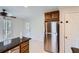 Well lit kitchen with stainless steel refrigerator and granite countertops island at 1975 Hunt Crossing Ct, Lawrenceville, GA 30043