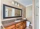 This is a primary bathroom with a granite vanity, tiled floors, and large framed mirror at 1975 Hunt Crossing Ct, Lawrenceville, GA 30043
