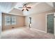 A spacious Primary bedroom with a tray ceiling, carpet and a view of the en-suite bathroom at 1975 Hunt Crossing Ct, Lawrenceville, GA 30043