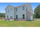 Two-story home with a well-maintained lawn, patio, and an attached rear-entry garage at 3387 Wild Clary Court Lot 20, Buford, GA 30519