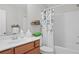 Bright bathroom with vanity and tub shower featuring decorative shower curtain at 3387 Wild Clary Court Lot 20, Buford, GA 30519