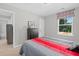 Cozy bedroom with neutral wall color, and a large window overlooking the backyard at 3387 Wild Clary Court Lot 20, Buford, GA 30519