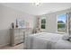 Inviting bedroom featuring bright windows, neutral walls, and dresser at 3387 Wild Clary Court Lot 20, Buford, GA 30519