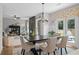 Dining area with a dark wood table and view into living room and backyard, offering a harmonious living space at 3387 Wild Clary Court Lot 20, Buford, GA 30519