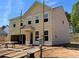 Two-story new construction home showing beige siding and an attached two-car garage at 3387 Wild Clary Court Lot 20, Buford, GA 30519