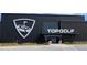 An exterior view of the Topgolf complex with modern architecture and prominent signage, offering entertainment and dining at 3387 Wild Clary Court Lot 20, Buford, GA 30519