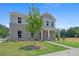Two-story home with a brick facade, covered front porch, and well-maintained lawn at 3387 Wild Clary Court Lot 20, Buford, GA 30519