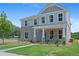 Beautiful two-story home features a brick facade, covered porch, and manicured lawn at 3387 Wild Clary Court Lot 20, Buford, GA 30519