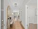 Inviting hallway featuring hardwood floors, neutral walls, and decorative lighting at 3387 Wild Clary Court Lot 20, Buford, GA 30519