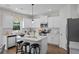 Modern kitchen with white cabinets, stainless steel appliances, and a center island with bar stools at 3387 Wild Clary Court Lot 20, Buford, GA 30519