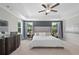 A luxurious main bedroom featuring a large bed, tray ceiling, and designer furnishings at 3387 Wild Clary Court Lot 20, Buford, GA 30519