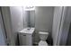 Bright bathroom includes a white vanity with sink, a toilet, and a large mirror at 4214 Canby Ln, Decatur, GA 30035