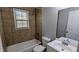 Cozy bathroom with tiled wall, shower over tub, toilet and a bright window at 4214 Canby Ln, Decatur, GA 30035
