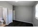 Cozy bedroom features gray walls, dark wood floors, and a closet near an attached bathroom at 4214 Canby Ln, Decatur, GA 30035