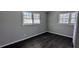 A bedroom with hardwood floors, gray walls, and two windows letting in plenty of natural light at 4214 Canby Ln, Decatur, GA 30035